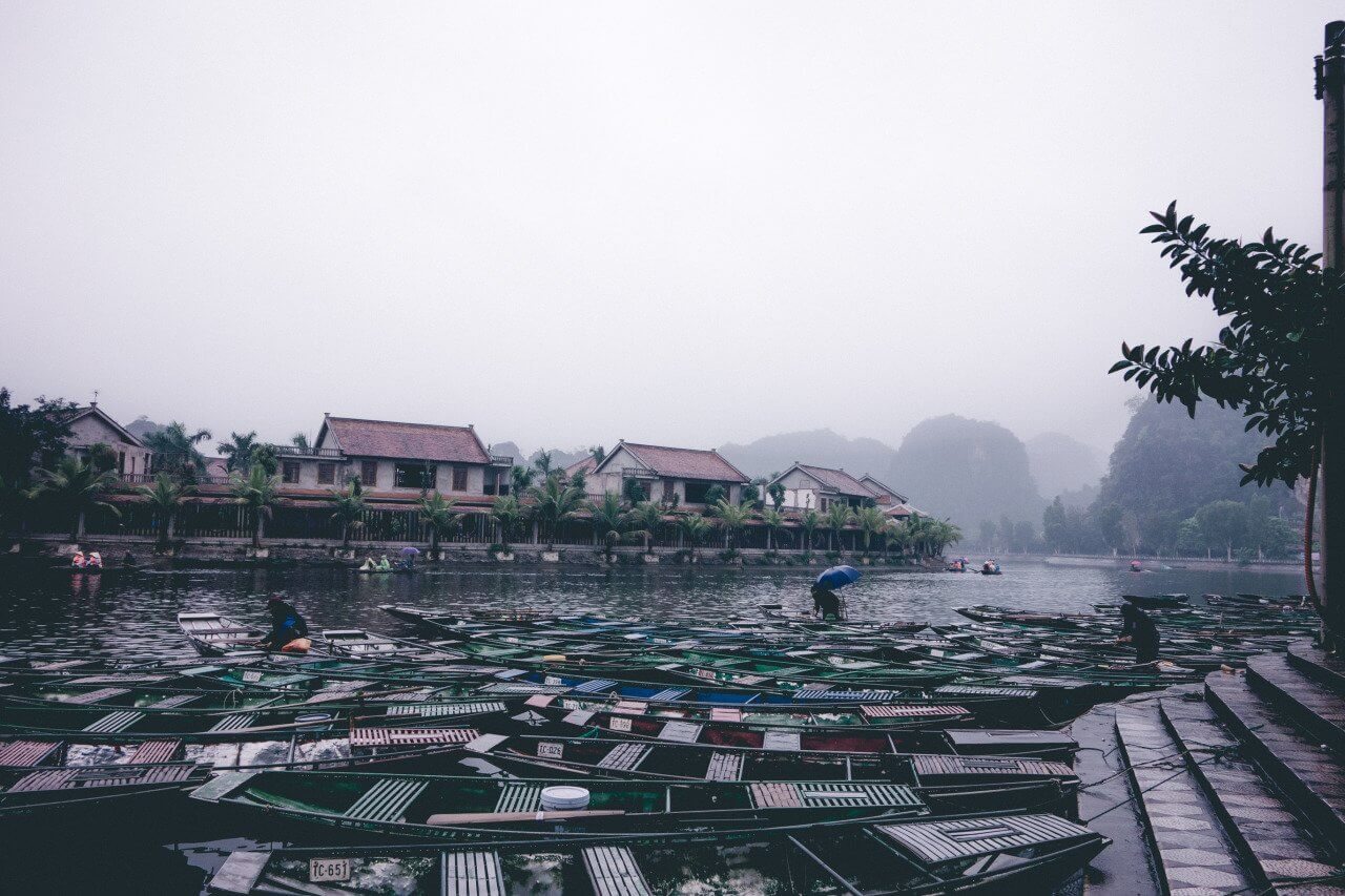 Several boats along the Tam Coc river in Ninh Binh, Vietnam.