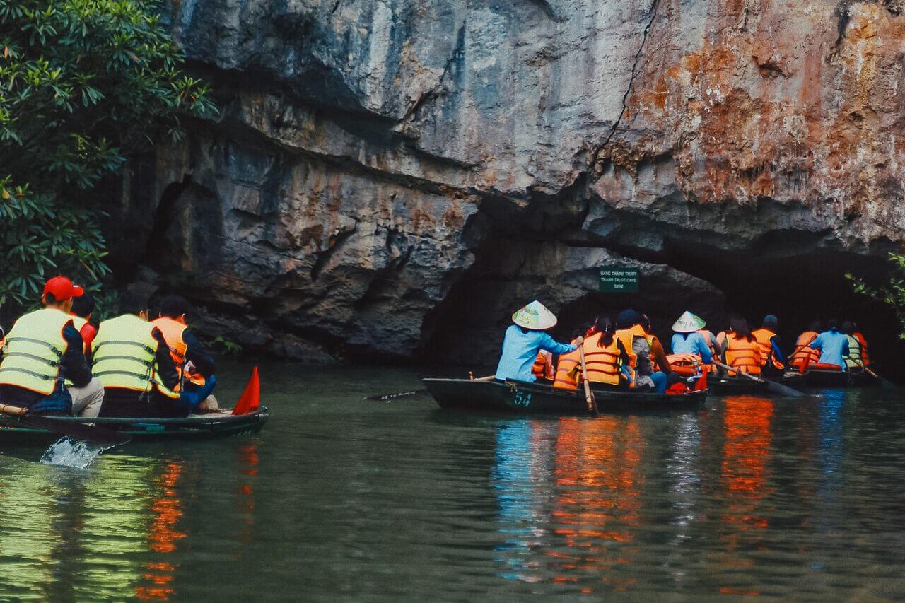A boat going under a cave in Ninh Binh
